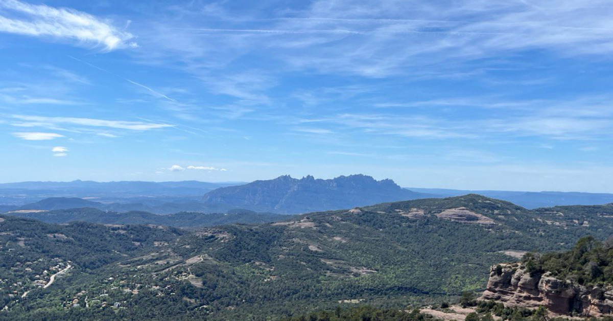 Mountains on the horizon under a blue sky.